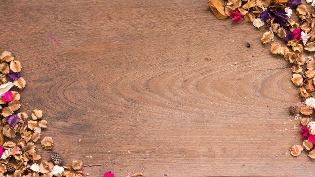 Top view workspace with dried flowers on wooden table background .Free space for your text.