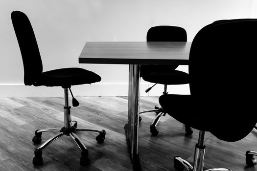 Table and chairs in a  conference room.black and white tone.