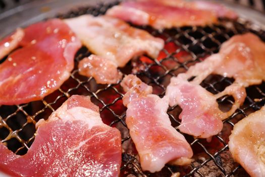 Pork grill on hot coals. This kind of food is a Korean or Japanese BBQ style.