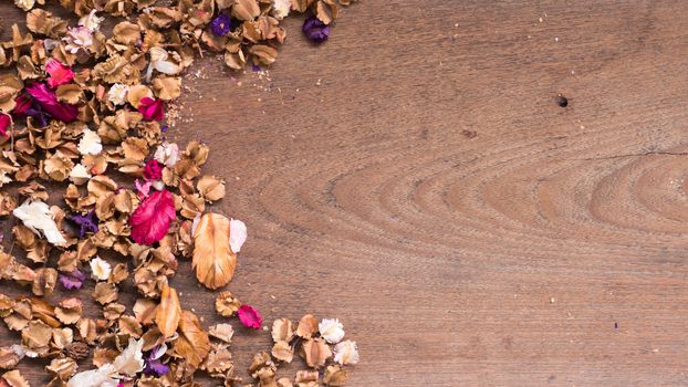 Top view workspace with dried flowers on wooden table background .Free space for your text.