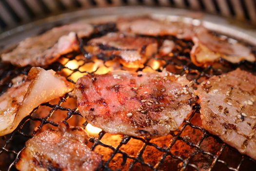 Pork grill on hot coals. This kind of food is a Korean or Japanese BBQ style.