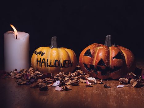 Halloween pumpkins with candlelight on dark background.