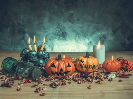 Halloween pumpkins with candlelight and skulls on dark background.Vintage tone