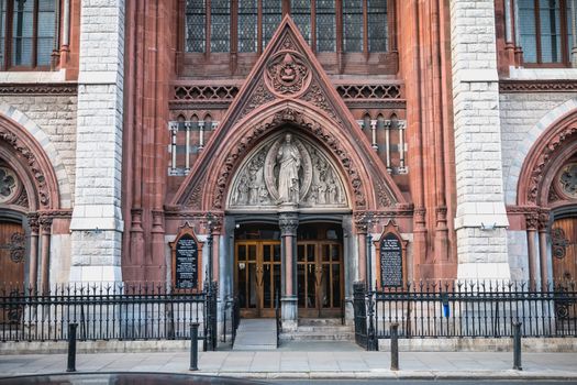 Dublin, Ireland - February 13, 2019: Street atmosphere and architecture of St. Augustine and St. John The Baptist Catholic Church that people visit on a winter day