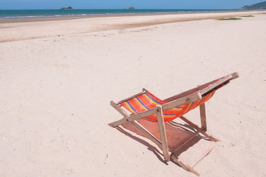 Red canvas chair on the beach.