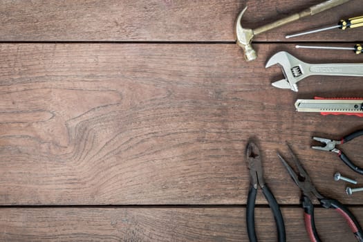 Many Tools on wooden table background.