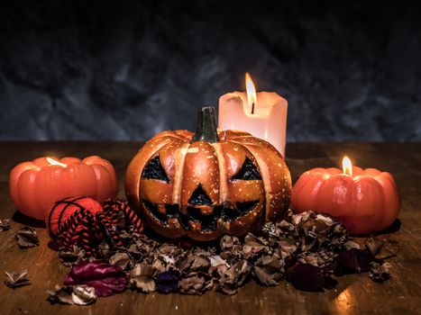 Halloween pumpkins with candlelight on dark background.