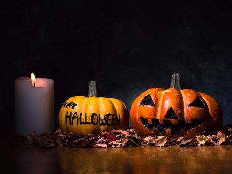 Halloween pumpkins with candlelight on dark background.