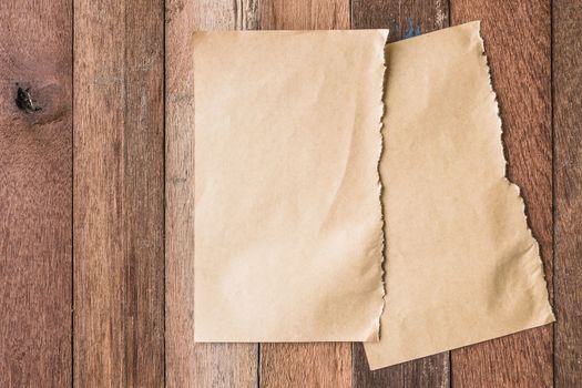 Top view of Blank brown paper on wooden table background.