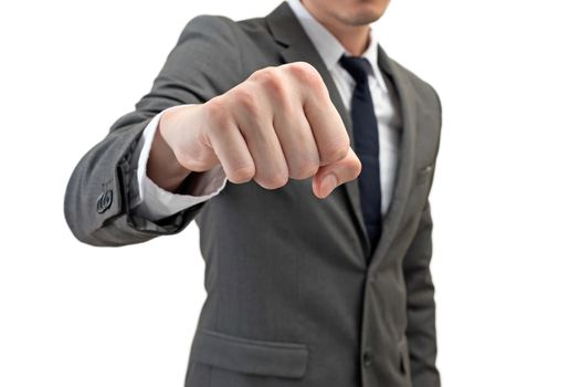 businessman holding his fist in front of him isolated on white background. business struggle