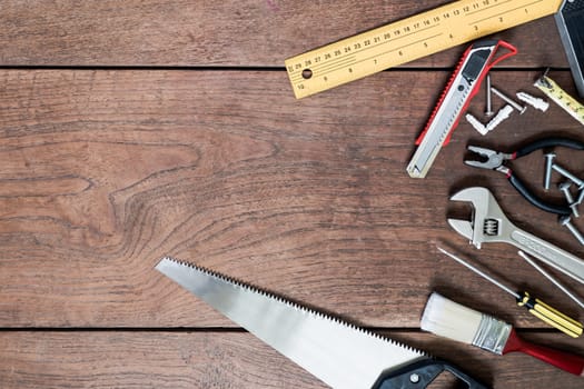 Many Tools on wooden table background.