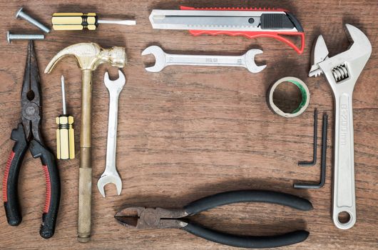 Many Tools on wooden table background.