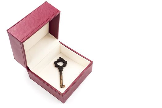 Metal key in red gift box on white background.