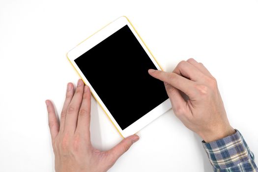 Male hands with a white tablet touch computer gadget with touch blank black screen on white background.