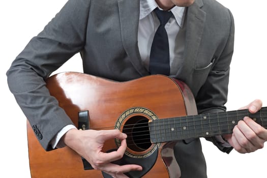 Businessman playing acoustic guitar isolated on white background.