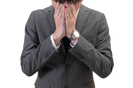 Businessman covering his face with hands isolated on white background.