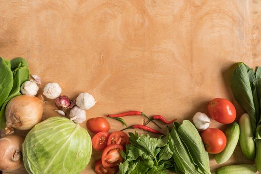 Top view of Fresh vegetables  on wooden table background.