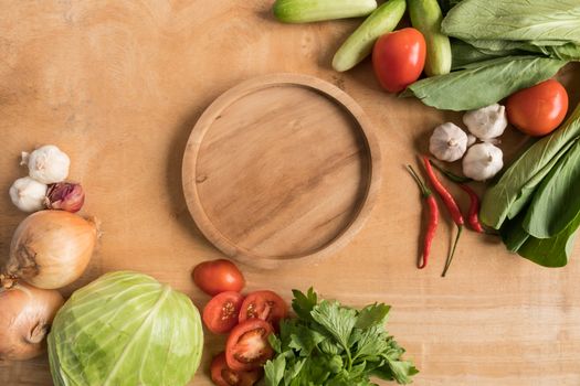 Top view of Fresh vegetables with wooden tray  on wooden table background.