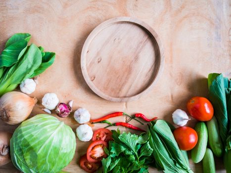 Top view of Fresh vegetables with wooden tray  on wooden table background.