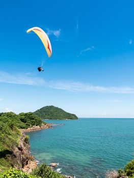 Beautiful seascape with Paraglider flying in blue sky.