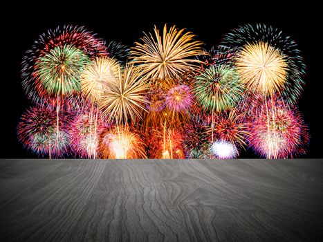 Empty wooden table in front of fireworks background.