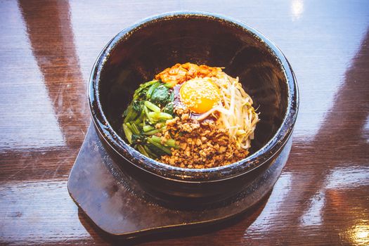 Bibimbap in a heated stone bowl, Korean food