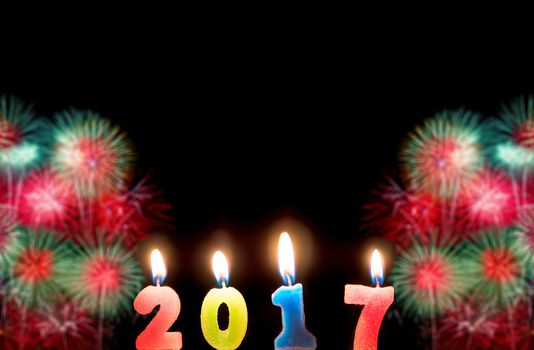 2017 candles numbers on fireworks background. New Year Concept