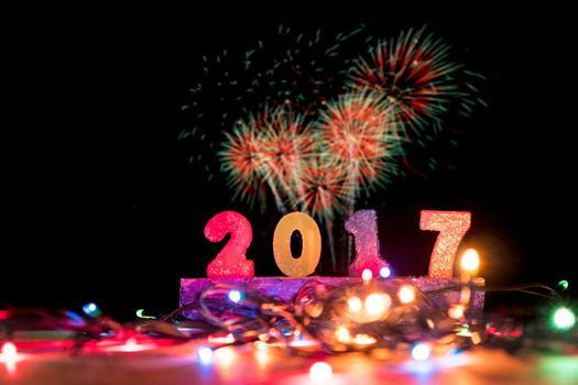 2017 numbers with christmas lights on fireworks background. New Year Concept