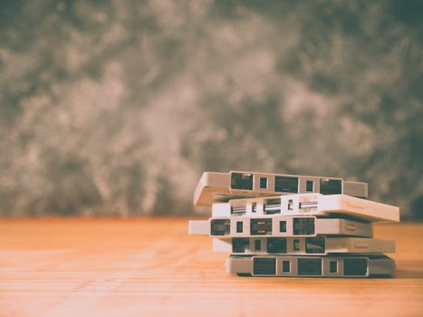 Cassette tapes over wooden table with grunge background.retro filter.