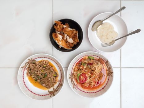 Top view of Papaya salad with Spicy minced pork,Fried chicken and Sticky rice,Thai local food