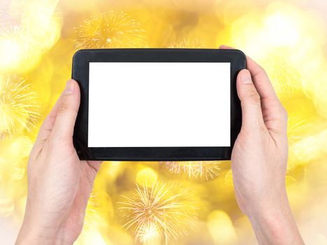 Male hand holding a tablet touch computer gadget with touch blank screen on bokeh lights and sparkle background.