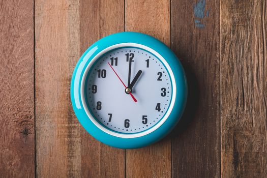 Top view of  Clock on wooden table background.