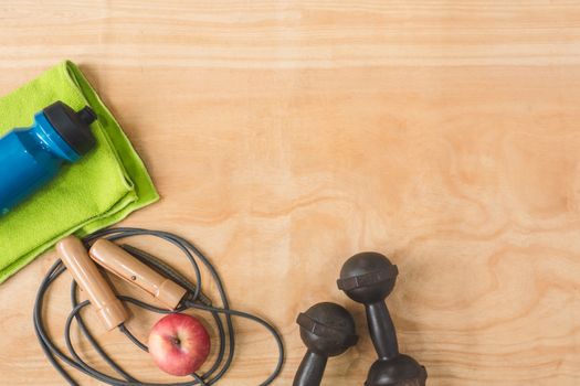 Top view of Sport stuff on wooden table background, Fitness lifestyle concept, Free space for text