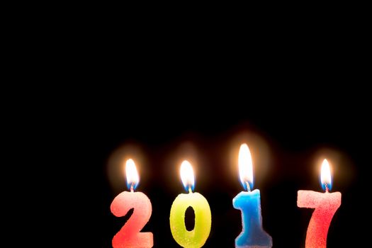 2017 candles numbers on black background. New Year Concept