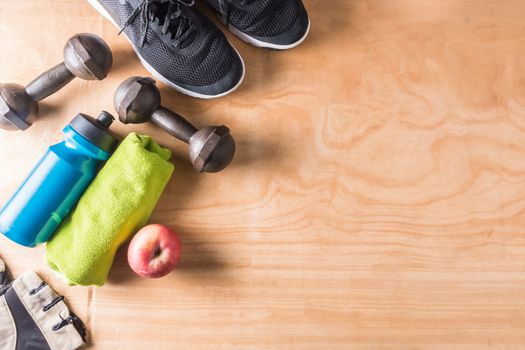 Top view of Sport stuff on wooden table background, Fitness lifestyle concept, Free space for text