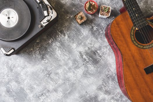 Top view of Vintage Turntable with Guitar and cactus on grunge background, Free space for text