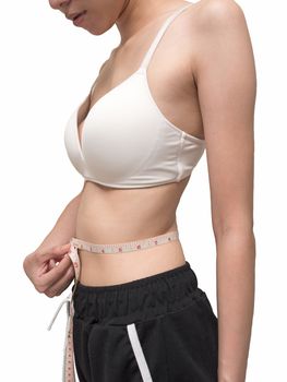 Close up of female body measuring her waist on white background, diet and healthy lifestyle