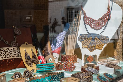 Obidos, Portugal - April 12, 2019: View of the window of a souvenir shop on a spring day with its reproductions of objects and clothing accessories formerly worn in historic city