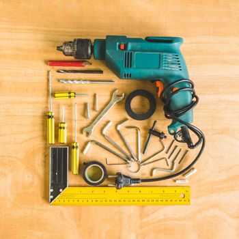 Set of different work tools on wooden table background.