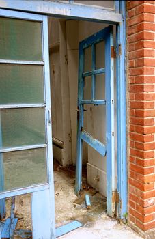 The broken door frame of a dilapidated and deserted building
