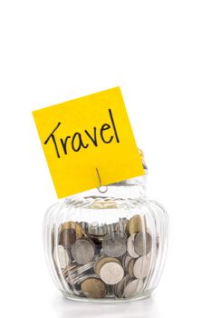 Coins in glass bottle on white background, saving money for Travel