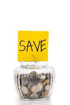 Coins in glass bottle on white background, saving money for Future
