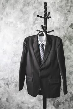 Black suit and tie and white shirt on grunge background.
