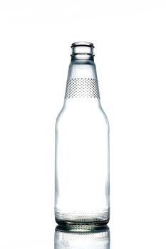 Empty colorless glass bottle on a white background.