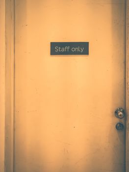 Staff only sign on a old door. Vintage tone