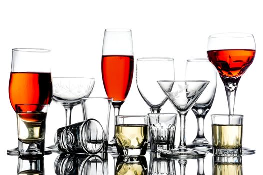 Collage of empty glasses with alcohol on white background.