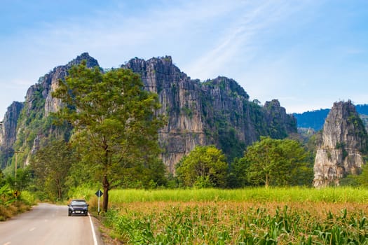 Beautiful landscape with road, mountains and blue sky. Travel concept