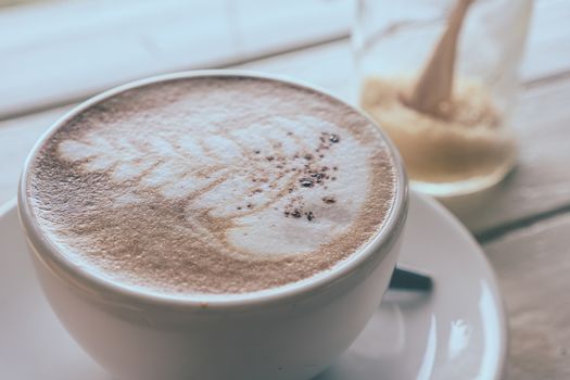 Cup of coffee on the wooden table, Soft focus, Vintage tone