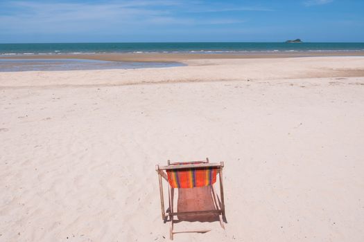 Red canvas chair on the beach.