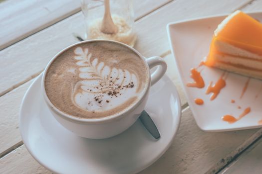 Coffee and orange cake on wooden table, Soft focus, Vintage tone